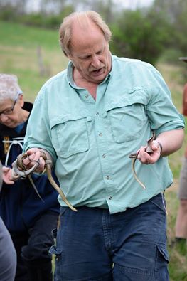 A photo of herpetologist Jim Andrews holding snakes